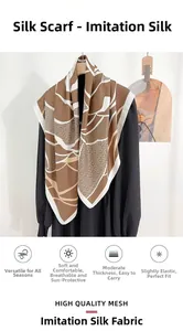 Detail of silk-like satin scarf featuring brown and white geometric patterns on a hanger