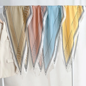 Elegant geometric stripe print faux silk diamond scarf in khaki, orange, and blue hues
