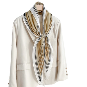 Artistic geometric stripe faux silk diamond scarf styled on a beige blazer for women
