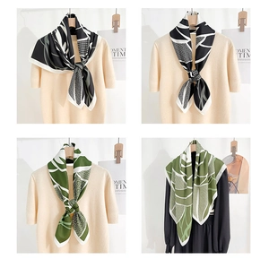 Detailed view of stylized twill silk scarves with abstract patterns on mannequins