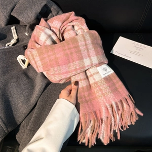 Pink and brown plaid thick scarf with tassels and brand label on wool coat