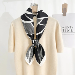 Elegant silk-like square scarf with black and white abstract floral print on beige knit top