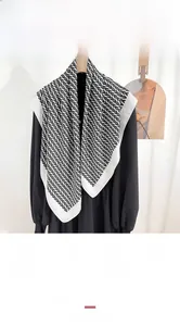 Detail of faux silk scarf featuring vintage black and white repeating V-pattern print