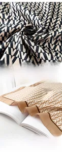 Detailed view of satin silk scarves featuring refined edge locking and V pattern print