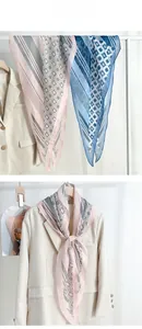 Detail view of lightweight diamond print silk scarves showing texture and draped styling