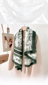 Detail of a 130cm vintage ethnic print scarf with frayed edges over a beige wool coat