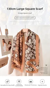 Detail of a large camel square scarf with white floral print and fringed edges on a coat