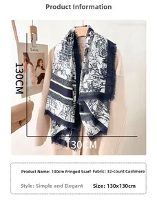Close-up of vintage navy blue printed scarf with fringe detailing on wool coat