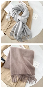 Detail view of knitted fringes on soft light grey and dusty pink cashmere-like scarves