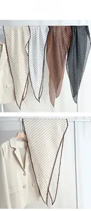 Close-up of semi-transparent polka dot scarves in four colors with high-quality stitching