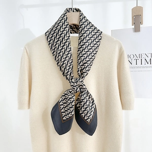Elegant silk-like square scarf with V-pattern geometric print on beige knit top