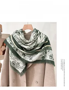 Detail view of green and white floral printed scarf with delicate fringe and soft wool texture