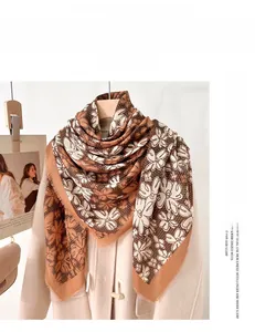 Detailed macro view of caramel floral print mercerized wool scarf with loose fringe edges