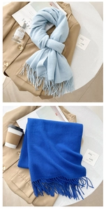 Detailed view of soft tassels on light blue and royal blue cashmere-feel scarves