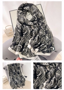 Macro detail of the paisley jacquard pattern on a black and white cotton linen shawl