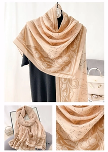 Detailed close-up of paisley and baroque pattern on beige cotton linen thin shawl