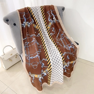 Elegant cotton linen equestrian scarf with horse bit chain print on a velvet chair