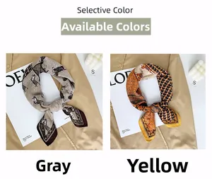 Detail view of premium silk scarves with grey horse and yellow geometric patterns