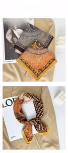 Detail of vintage geometric silk-feel scarf featuring heritage horse print and lattice pattern