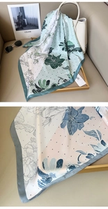 Detail of silk-like floral square scarf with elegant rose print and soft texture