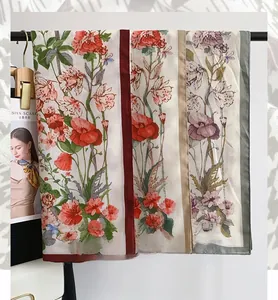 Close-up of 90x90 herringbone square scarves with vintage floral prints in multiple colors