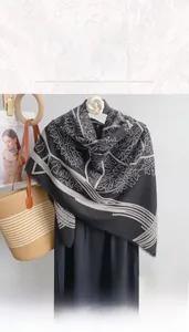 Detailed shot of large 130cm square paisley scarf with elegant fringe and monochrome patterns