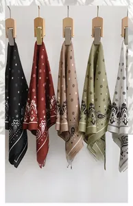 Detailed view of five herringbone square scarves in black, burgundy, khaki, green, and white