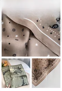 Detailed view of herringbone fabric texture with paisley and star pattern on square scarf