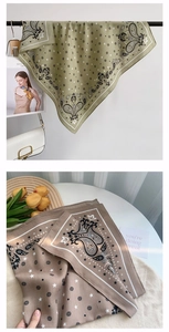 Detail view of paisley print square scarves in olive and brown with soft silk luster