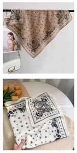 Detail view of paisley print square scarves in brown and cream with vintage floral patterns