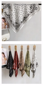 Detail of silk square scarves featuring paisley patterns and five different elegant colors