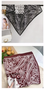 Detailaufnahme von Paisley-Mustern auf Seidenschals in klassischem Schwarz und Burgunder