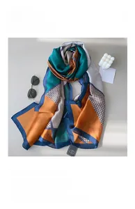 Detailed view of silky satin scarf featuring geometric color blocks and houndstooth pattern