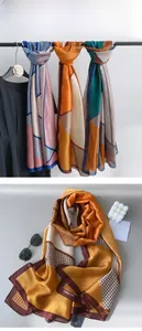 Detail view of geometric silk scarf featuring houndstooth pattern and color block design