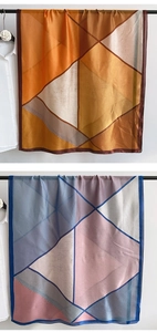 Detail of elegant geometric silk-feel scarf with chic houndstooth pattern collage