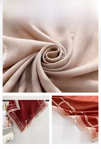 Detailed herringbone texture and chain pattern on elegant light beige and red silk scarves