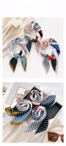 Detailed view of elegant printed silk scarves with modern abstract geometric patterns