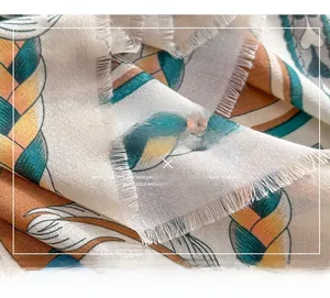 Detail of printed mercerized wool scarf with tassels and colorful braided patterns