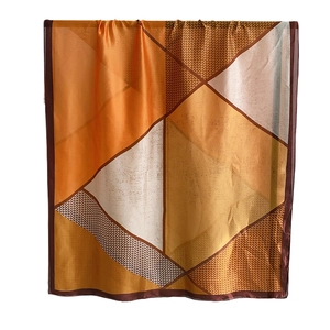 Elegant geometric color-block silk scarf with bright orange, yellow and houndstooth patterns
