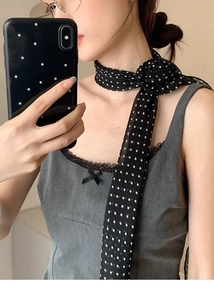 Foulard en soie à pois noué en forme de rose 3D autour du cou d'une femme