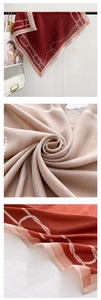 Detail of herringbone weave silk scarf with classic chain pattern and striped border