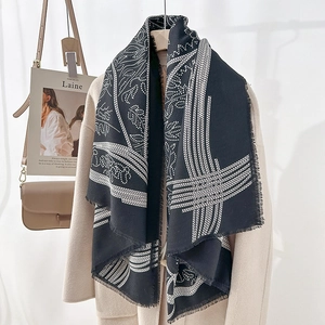 Elegant black and white printed scarf with tassel edges and abstract leaf patterns