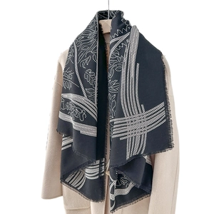 Ethnic retro square scarf with black and white print and fringe edge on beige coat