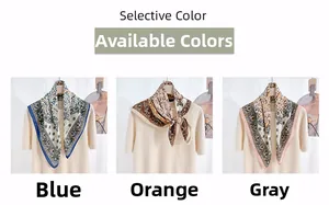 Detail view of floral paisley pattern neck scarves in blue, orange and grey silk fabric