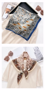 Detail of elegant paisley silk scarves with vibrant prints on a soft knitted background