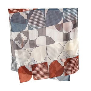 Elegant geometric patterned silk scarf in blue and orange colors with houndstooth texture
