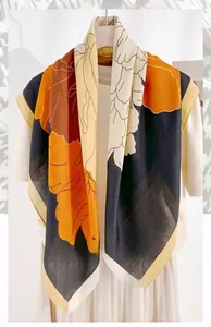 Detail of 90cm square silk scarf featuring a floral herringbone pattern in caramel and brown