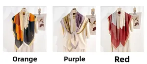 Detailed view of floral pattern scarves in orange, purple and red color options