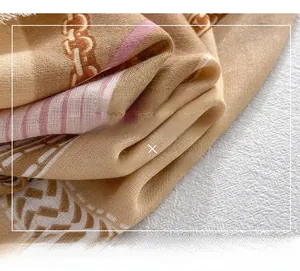 Detailed macro shot of camel silk-mercerized wool scarf with elegant chain patterns