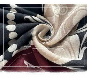 Macro view of retro printed mercerized wool scarf with vintage paisley and polka dot patterns